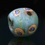 Ancient green glass bead with mosaic cane eyes,  3-1 century BC